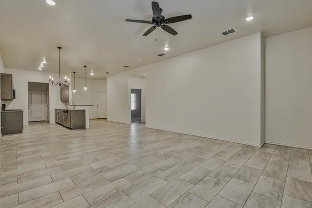 wooden floor in an empty room with a kitchen