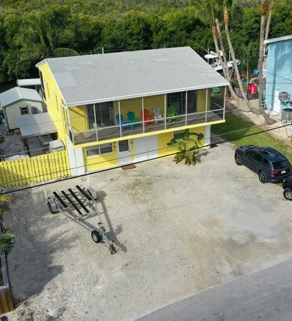 a view of pool with a yard and a large tree