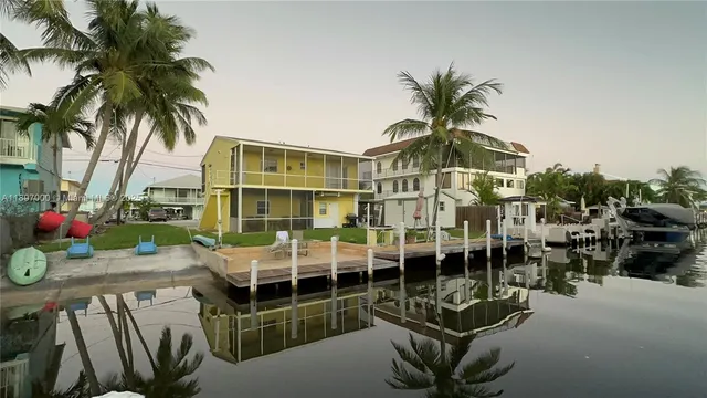 a front view of a building with glass windows and palm tree