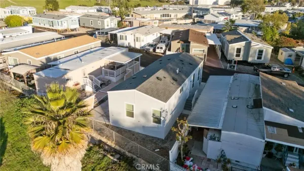 an aerial view of residential houses with city view