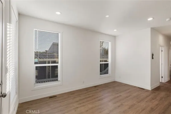 a view of a livingroom with wooden floor and a window