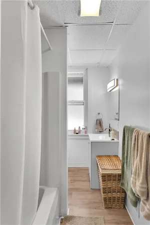 a living room with furniture a rug and white walls
