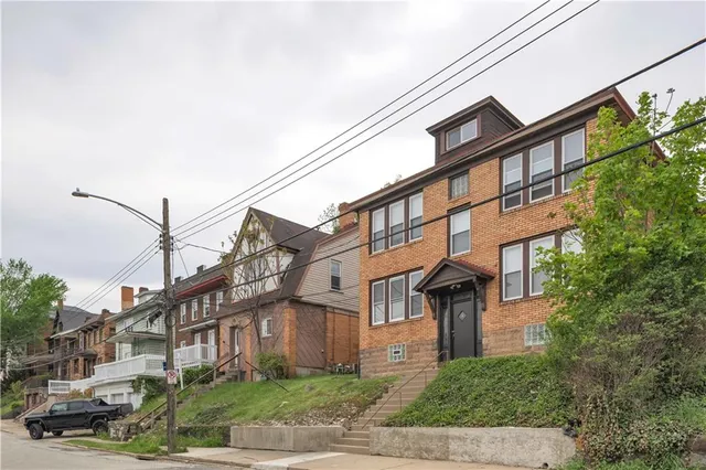a front view of a building with garden