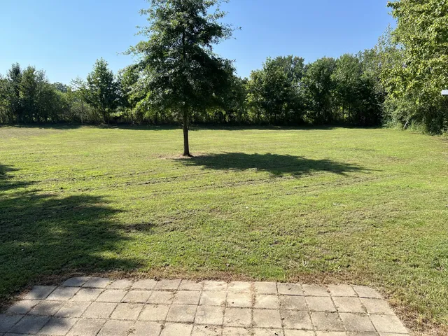a view of a swimming pool and a yard