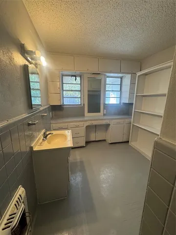 a bathroom with a sink a toilet a mirror and bathtub