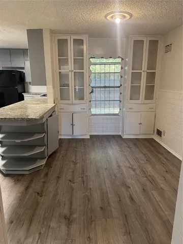 a kitchen with granite countertop a refrigerator and a stove