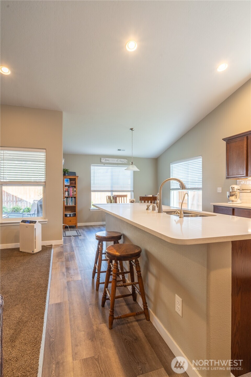 1630 Filmore Drive Moses Lake, WA 98837 - Photo 8 of 40 a view of a kitchen with kitchen island a large window a sink and counter space