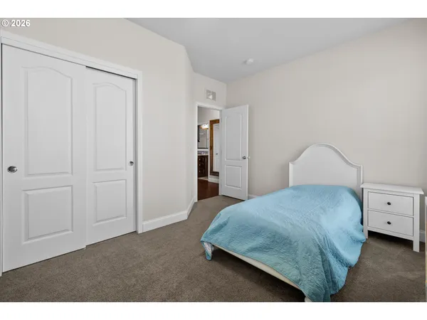 a bedroom with a bed and cabinet