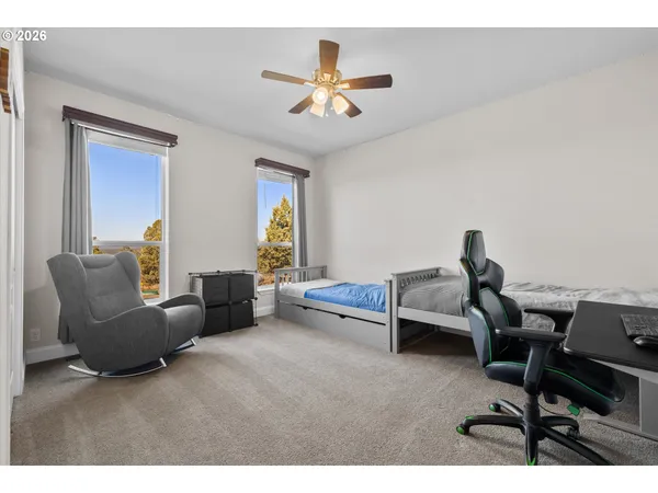 a living room with furniture and a ceiling fan
