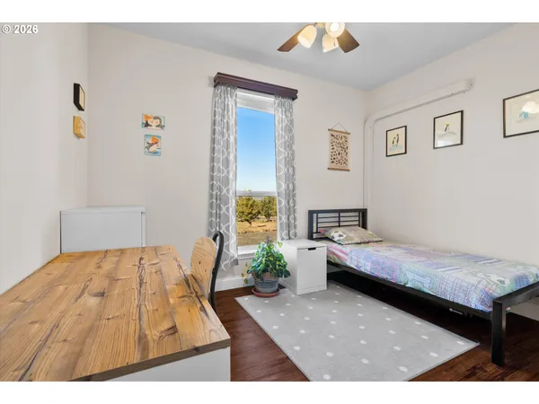 a bedroom with a bed window and a table