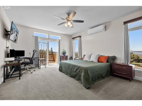 a spacious bedroom with a bed and a chandelier