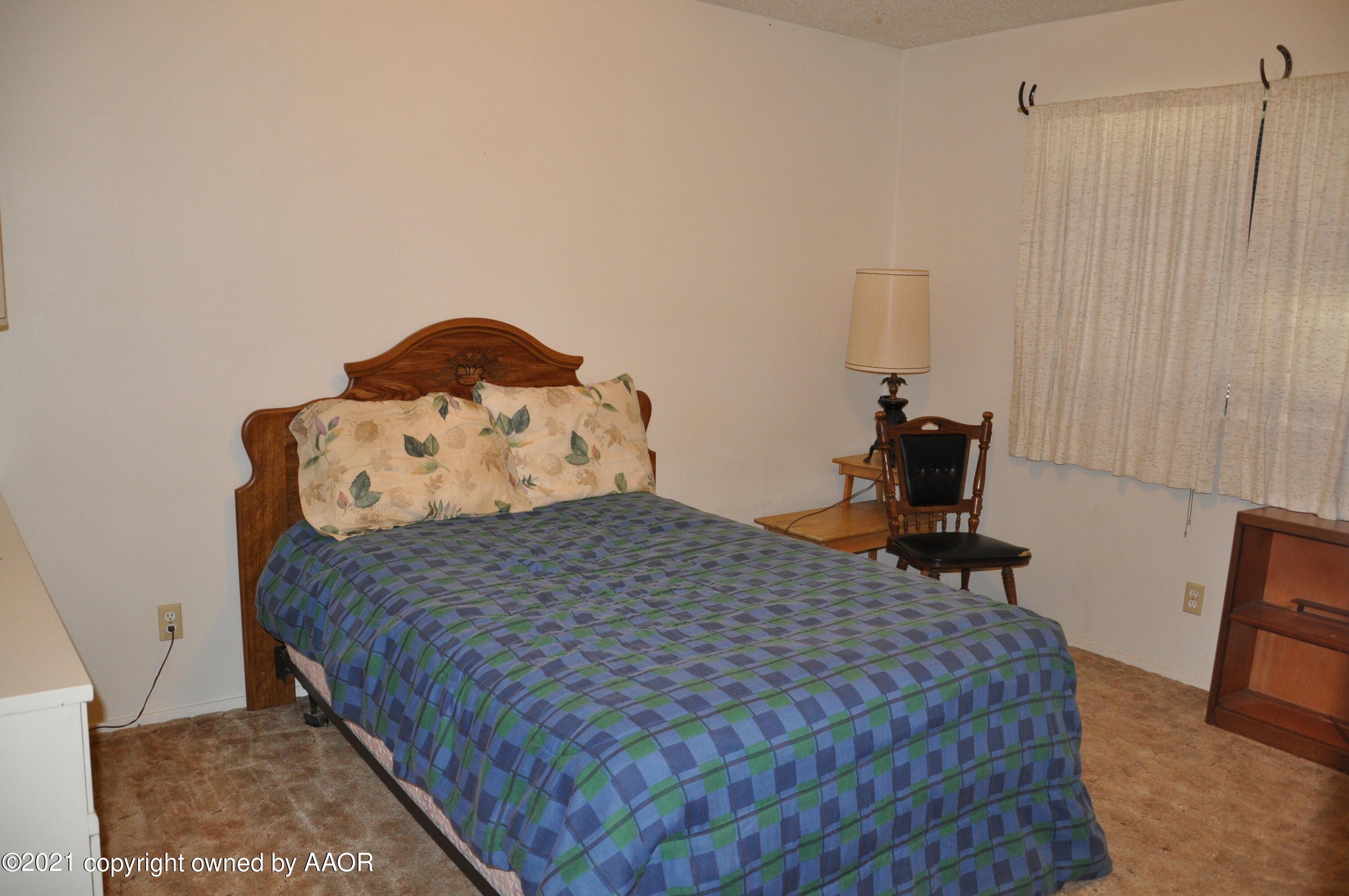 401 Mesa View Miami, TX 79059 - Photo 15 of 26 a bedroom with a bed and a chair