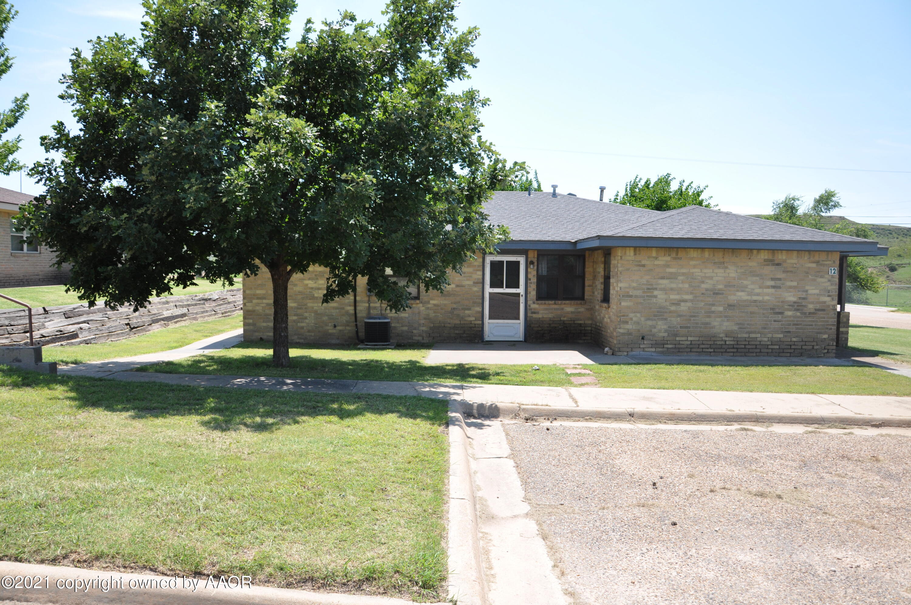 401 Mesa View Miami, TX 79059 - Photo 3 of 26 a front view of a house with a yard and garage