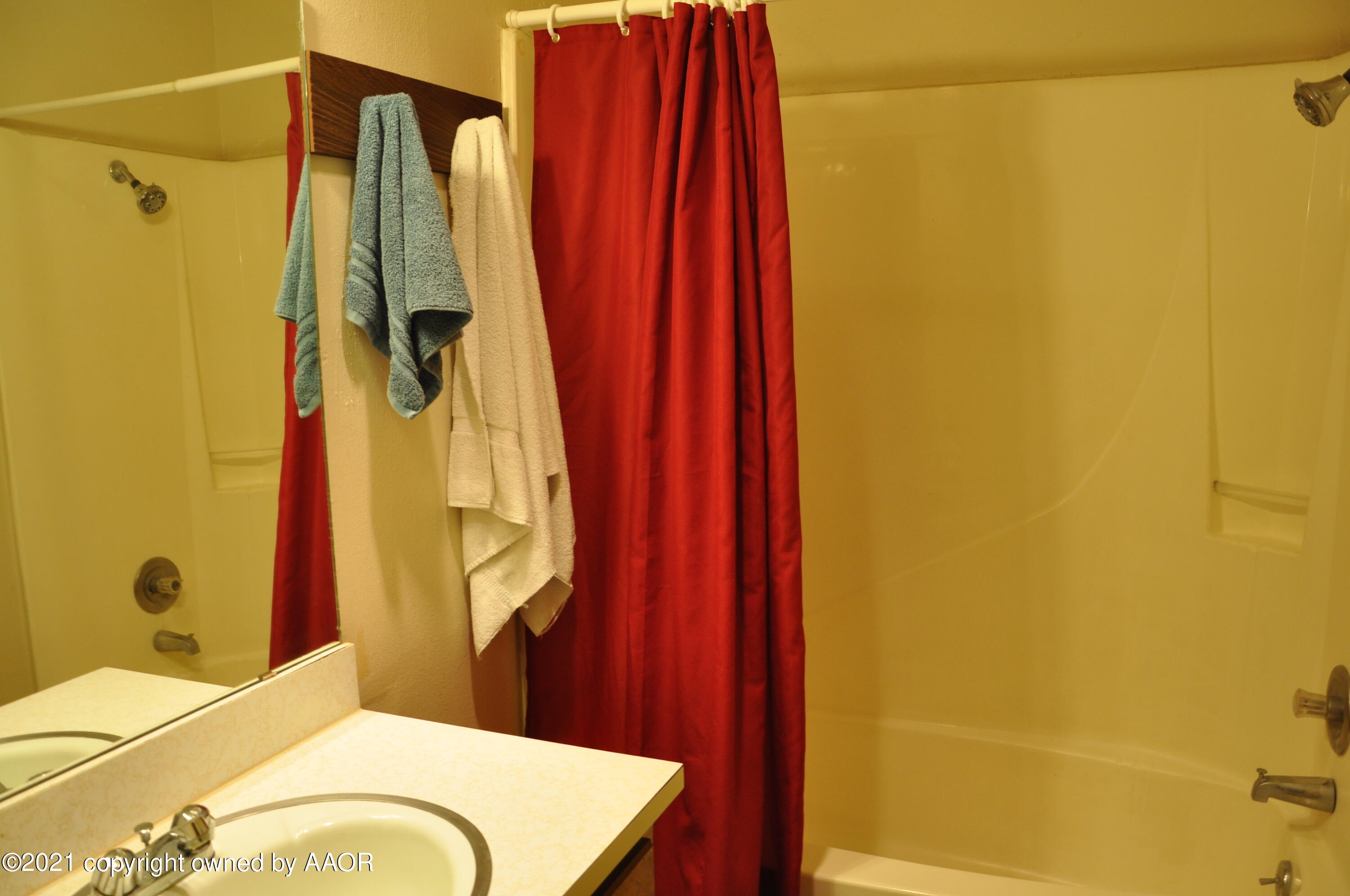 401 Mesa View Miami, TX 79059 - Photo 21 of 26 a bathroom with a granite countertop sink and a shower