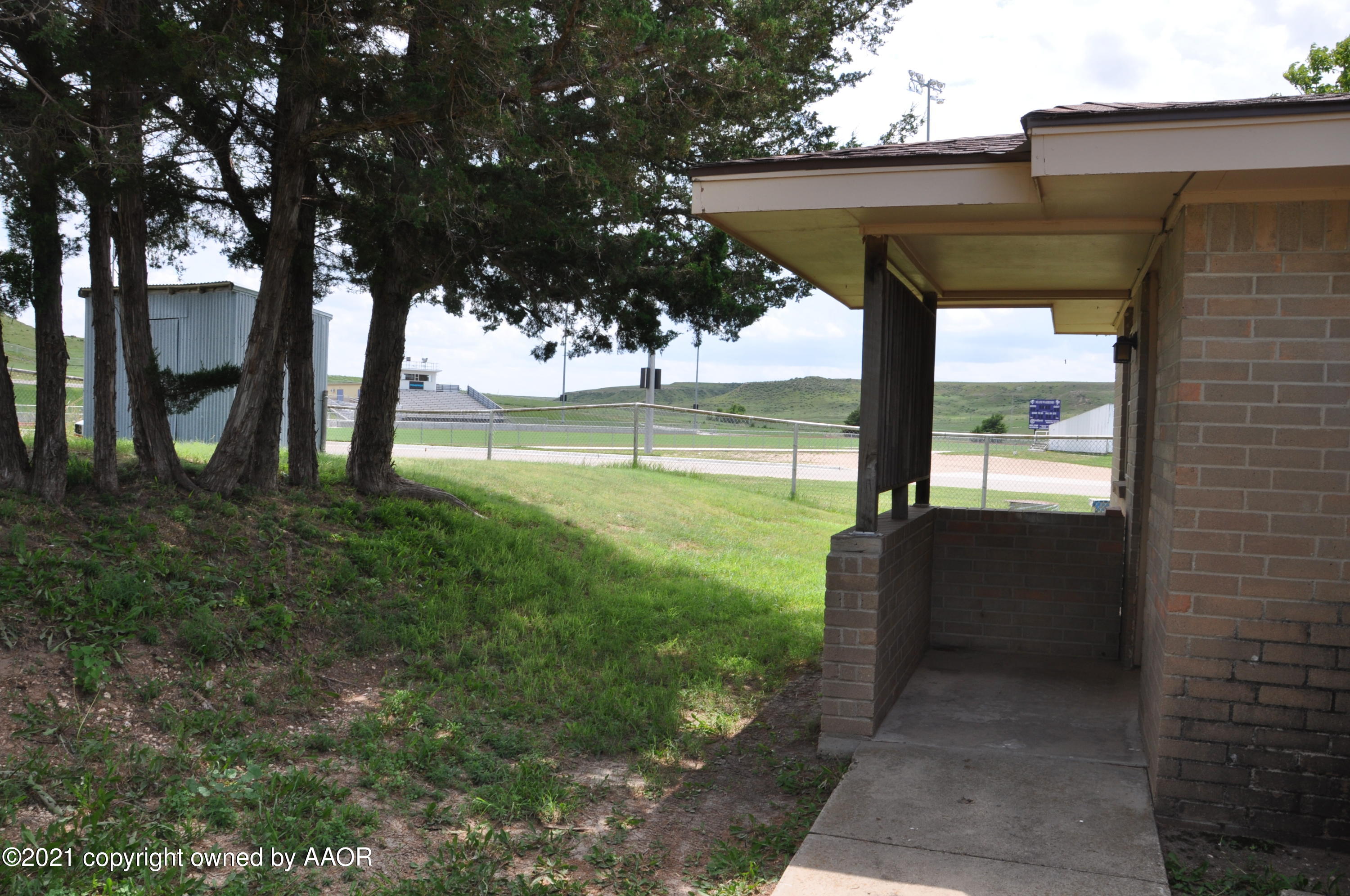 401 Mesa View Miami, TX 79059 - Photo 23 of 26 a view of a porch with a floor to ceiling window and a yard