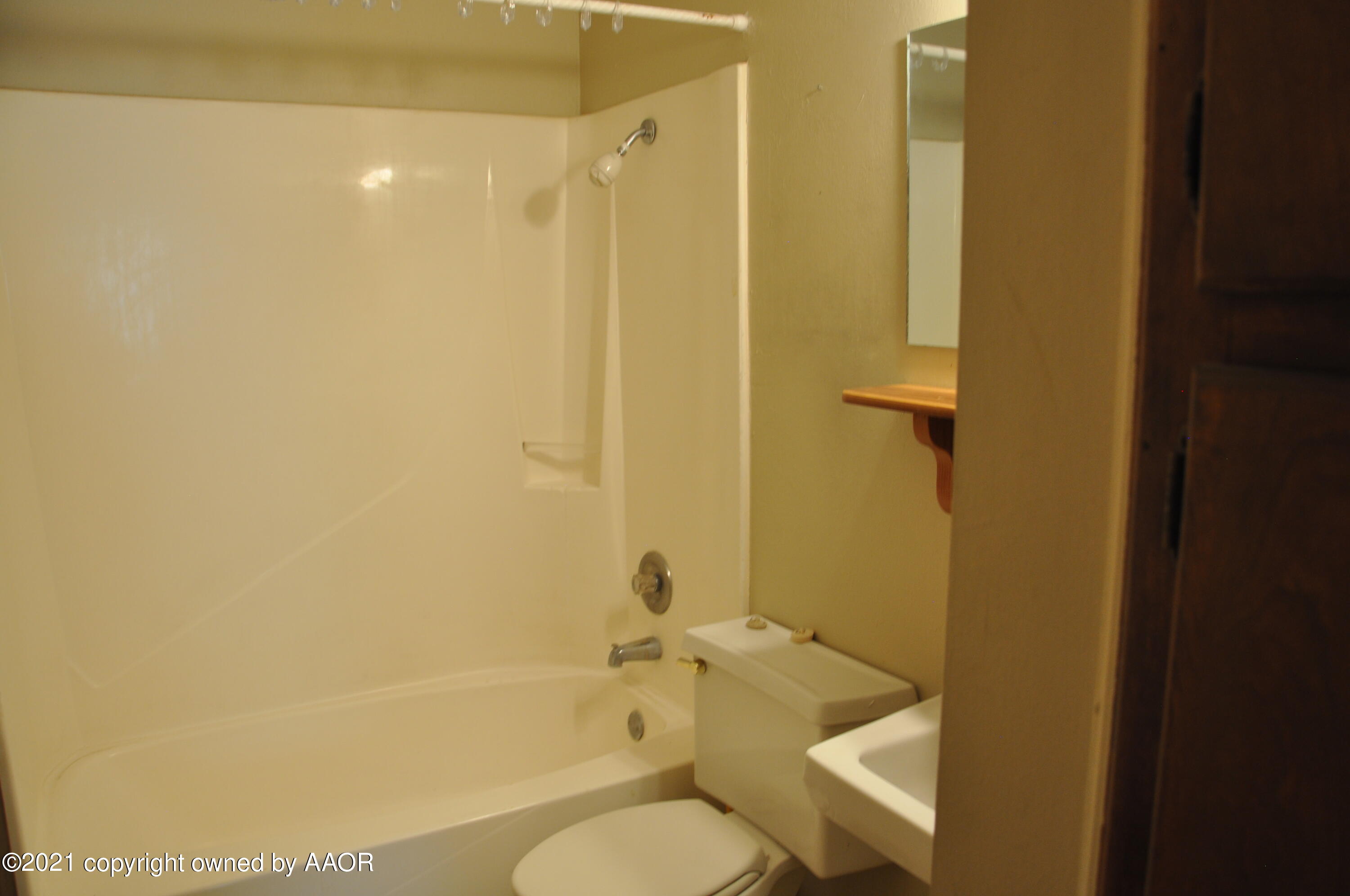 401 Mesa View Miami, TX 79059 - Photo 8 of 26 a bathroom with a granite countertop toilet a sink and shower
