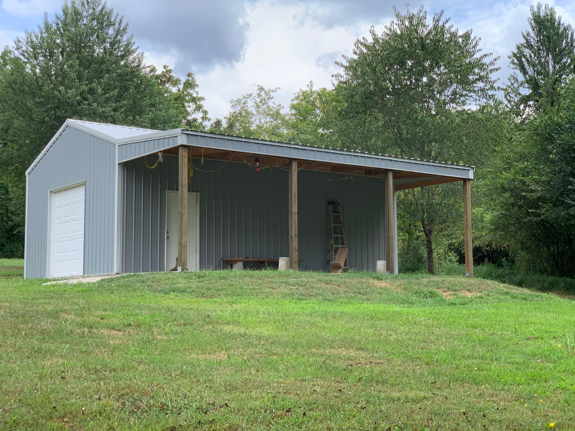 350 Sands Road Pulaski, TN 38478 - Photo 10 of 20 a backyard of a house with large trees and brick wall