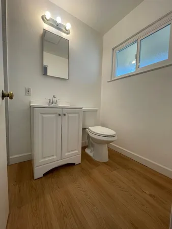 a bathroom with a toilet sink and mirror
