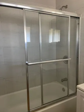 a bathroom with a glass shower door