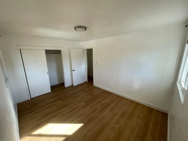 a view of empty room and wooden floor