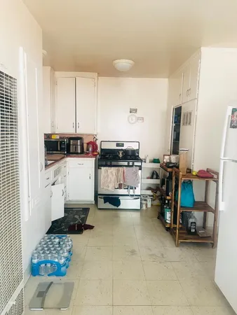 a kitchen with a sink and a stove top oven