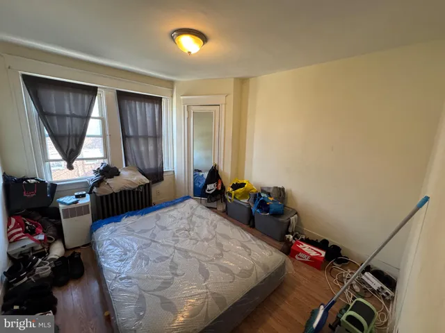 a bedroom with bed and a window