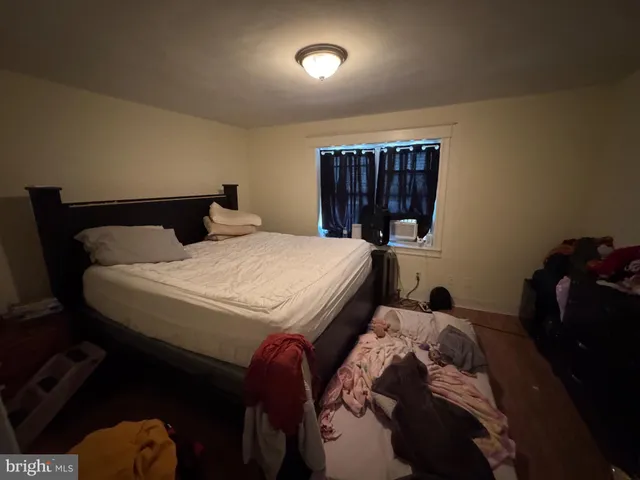 a bedroom with a bed and a television