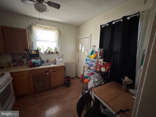 a kitchen with a table chairs refrigerator and microwave