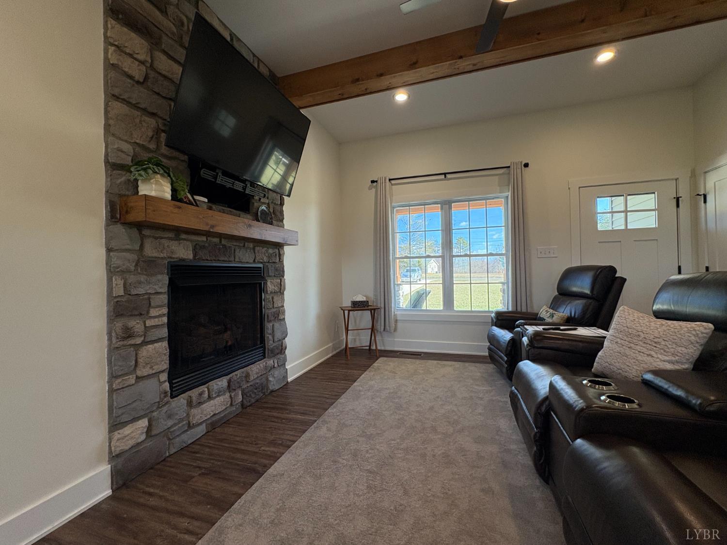 2142 Clarks Road Rustburg, VA 24588 - Photo 22 of 70 a living room with furniture a flat screen tv and a fireplace