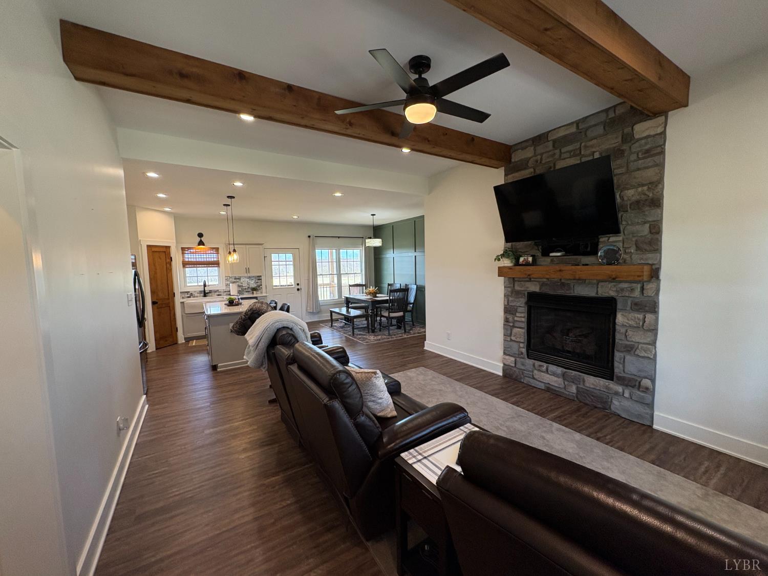 2142 Clarks Road Rustburg, VA 24588 - Photo 28 of 70 a living room with furniture a flat screen tv and a fireplace