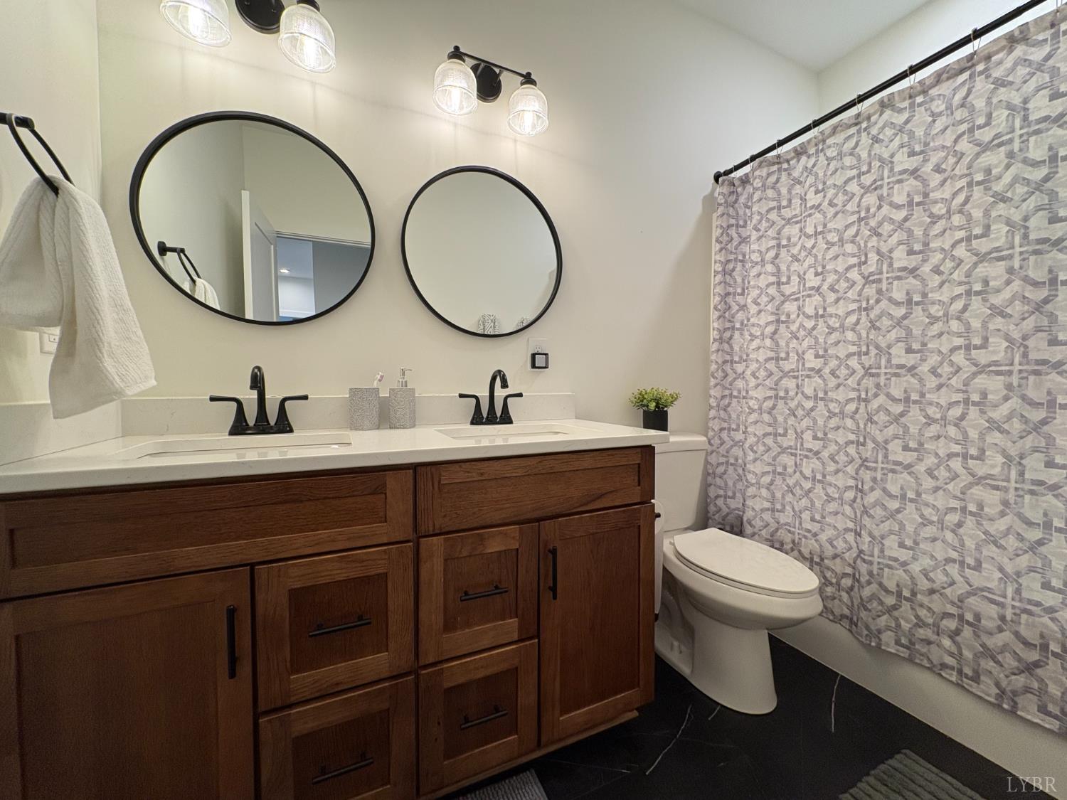 2142 Clarks Road Rustburg, VA 24588 - Photo 29 of 70 a bathroom with a toilet a sink and a mirror