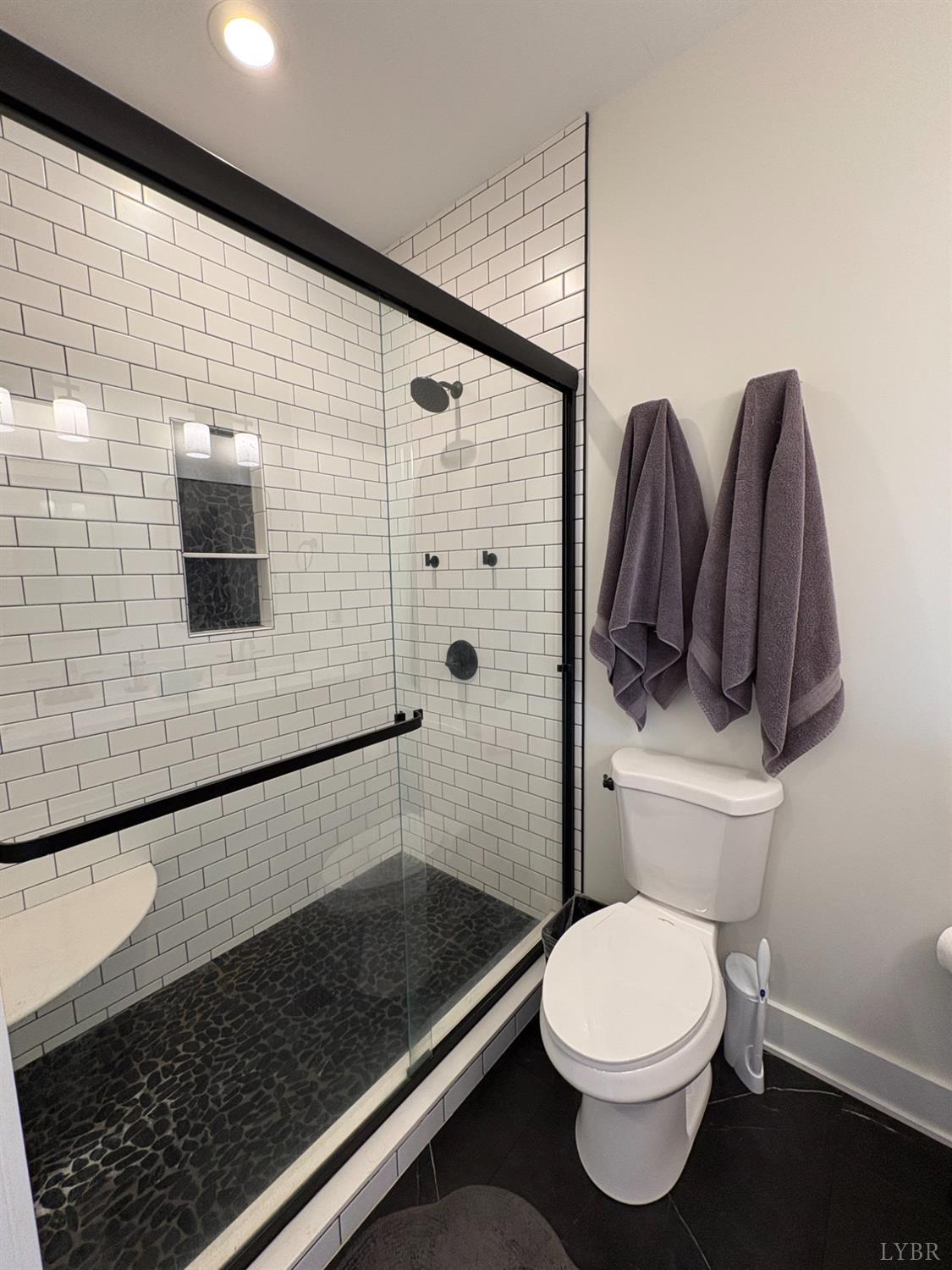 2142 Clarks Road Rustburg, VA 24588 - Photo 45 of 70 a bathroom with a toilet a sink and shower