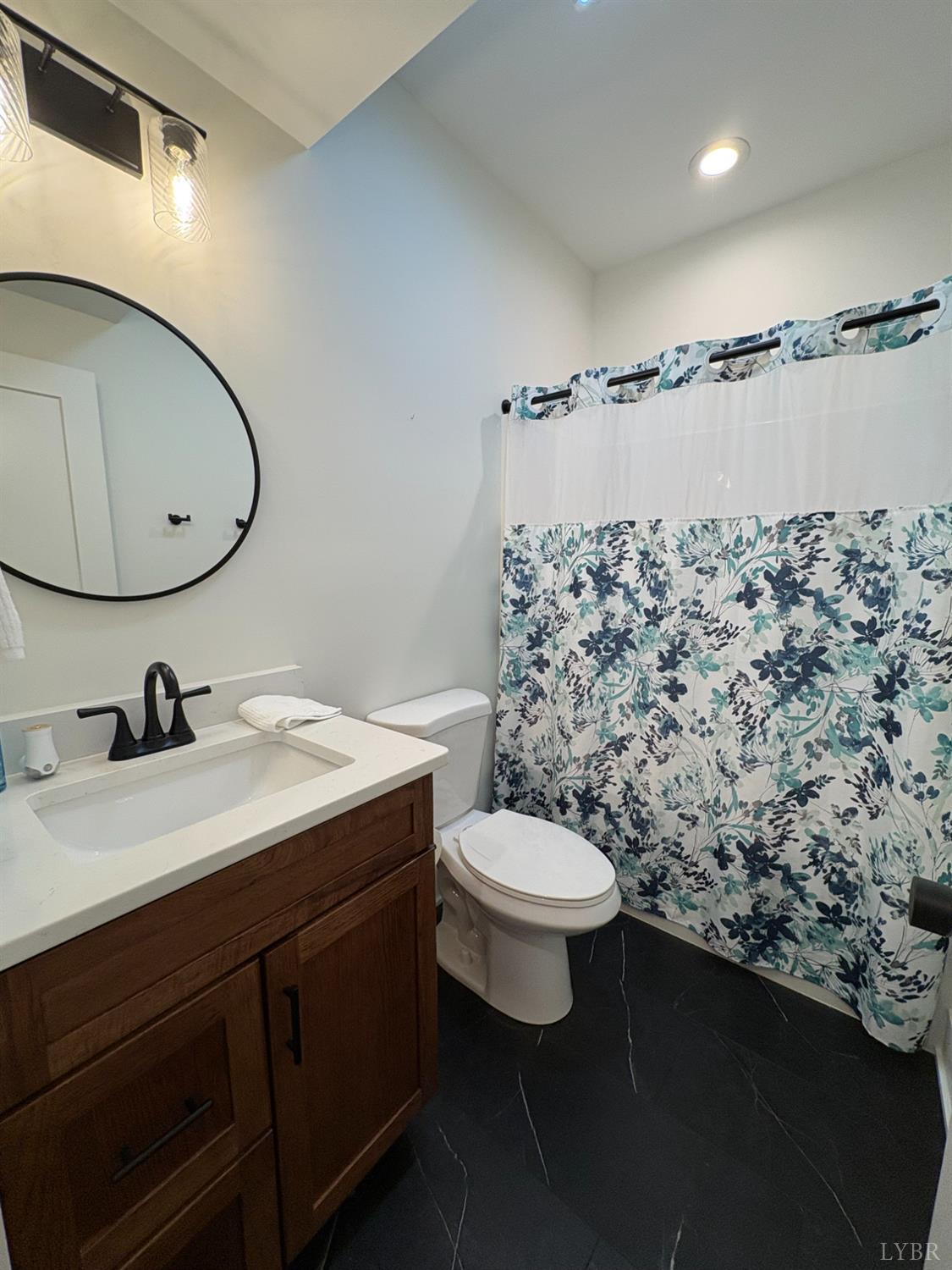 2142 Clarks Road Rustburg, VA 24588 - Photo 50 of 70 a bathroom with a sink toilet and mirror