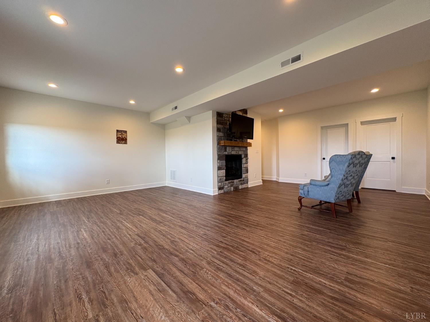 2142 Clarks Road Rustburg, VA 24588 - Photo 55 of 70 a view of empty room with wooden floor and lounge chair