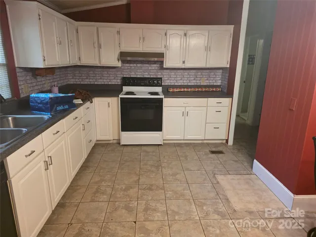a kitchen with a stove top oven and cabinets