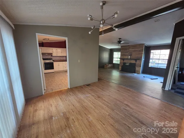 a view of a livingroom with a furniture wooden floor and staircase