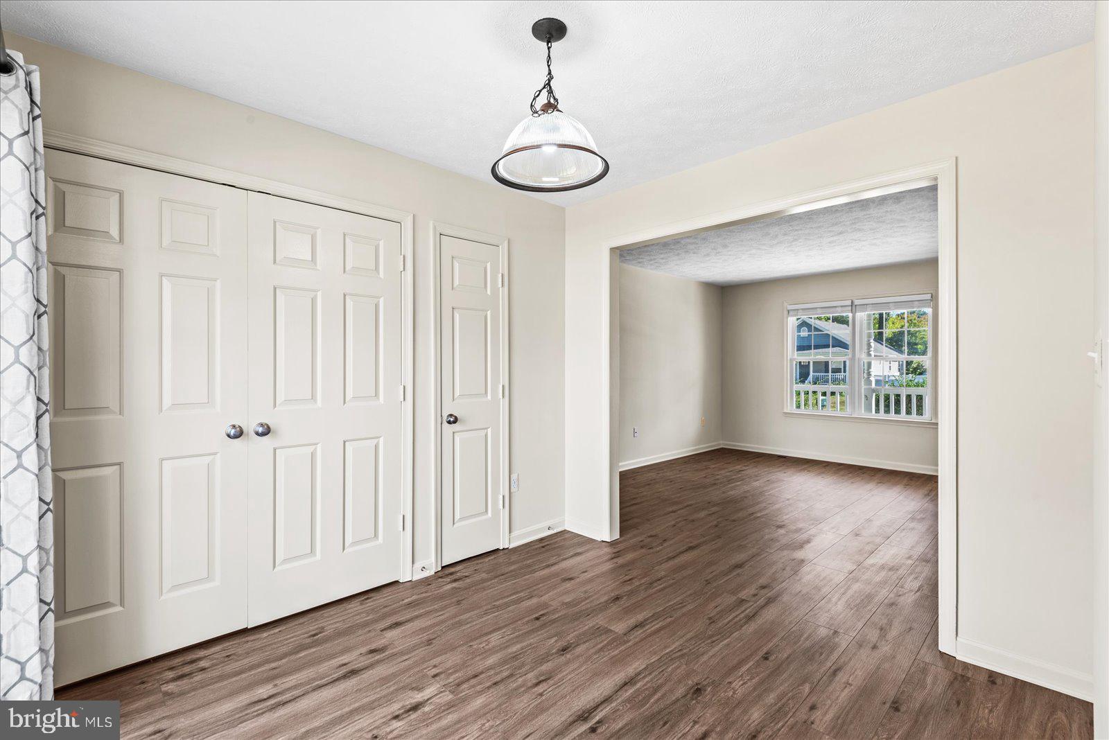321 3rd Street Colonial Beach, VA 22443 - Photo 13 of 47 a view of an empty room with wooden floor and a window
