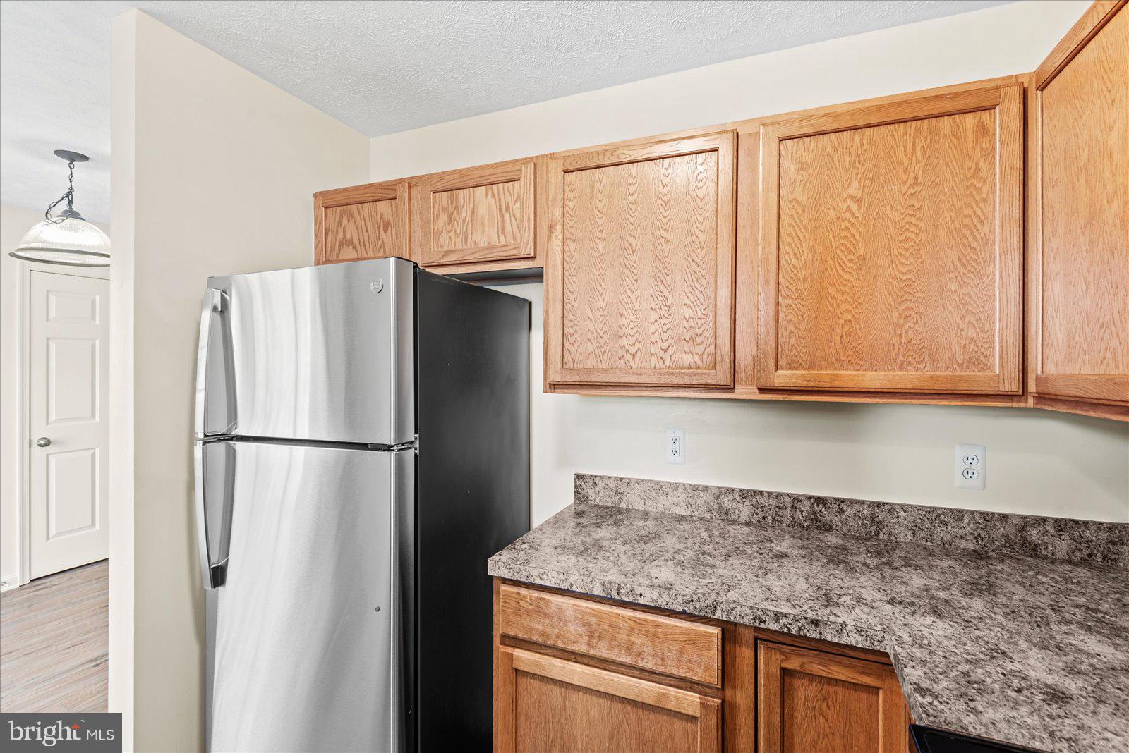 321 3rd Street Colonial Beach, VA 22443 - Photo 17 of 47 a kitchen with granite countertop a refrigerator and a sink
