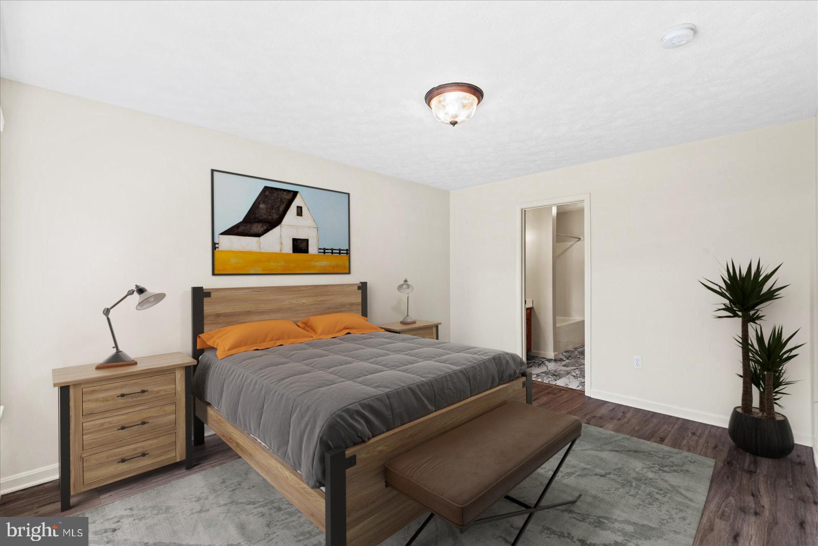 321 3rd Street Colonial Beach, VA 22443 - Photo 24 of 47 a bedroom with a bed and wooden floor