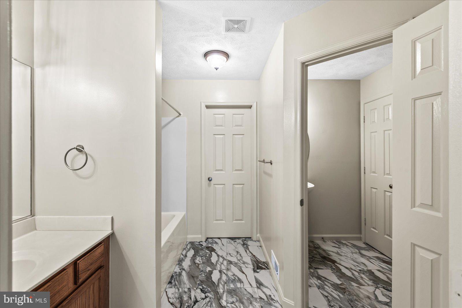 321 3rd Street Colonial Beach, VA 22443 - Photo 25 of 47 a bathroom with a sink and a mirror