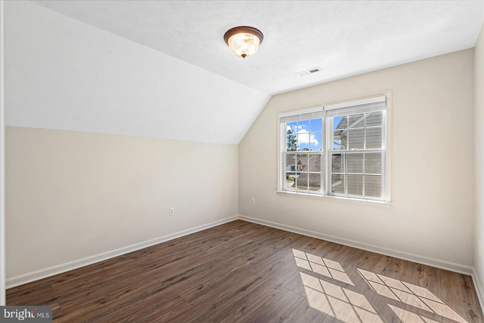 321 3rd Street Colonial Beach, VA 22443 - Photo 29 of 47 an empty room with wooden floor and windows