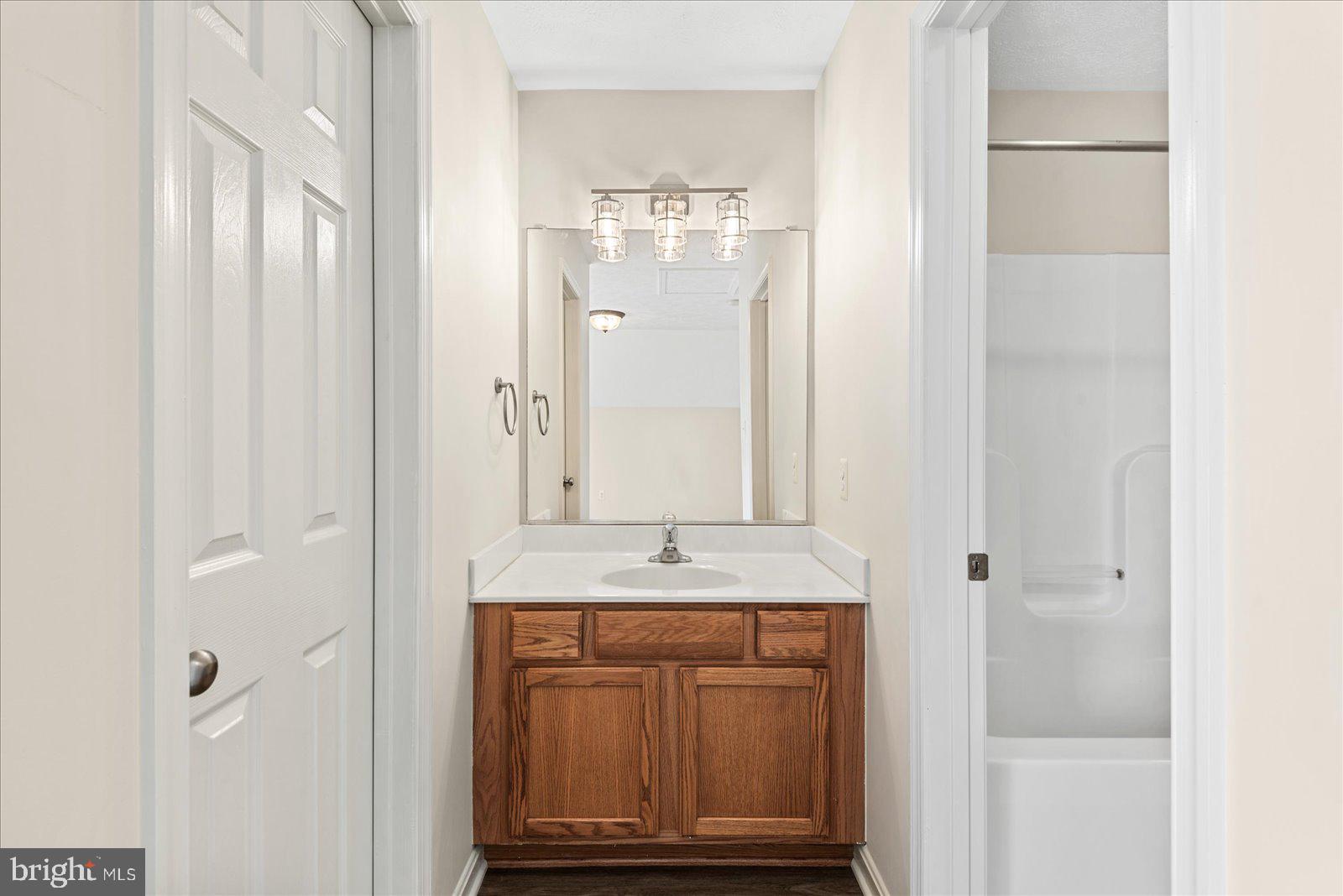 321 3rd Street Colonial Beach, VA 22443 - Photo 31 of 47 a bathroom with a granite countertop mirror and a sink