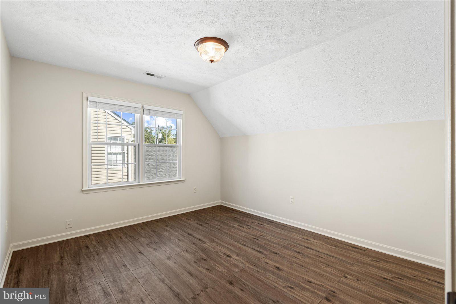 321 3rd Street Colonial Beach, VA 22443 - Photo 33 of 47 an empty room with wooden floor and windows