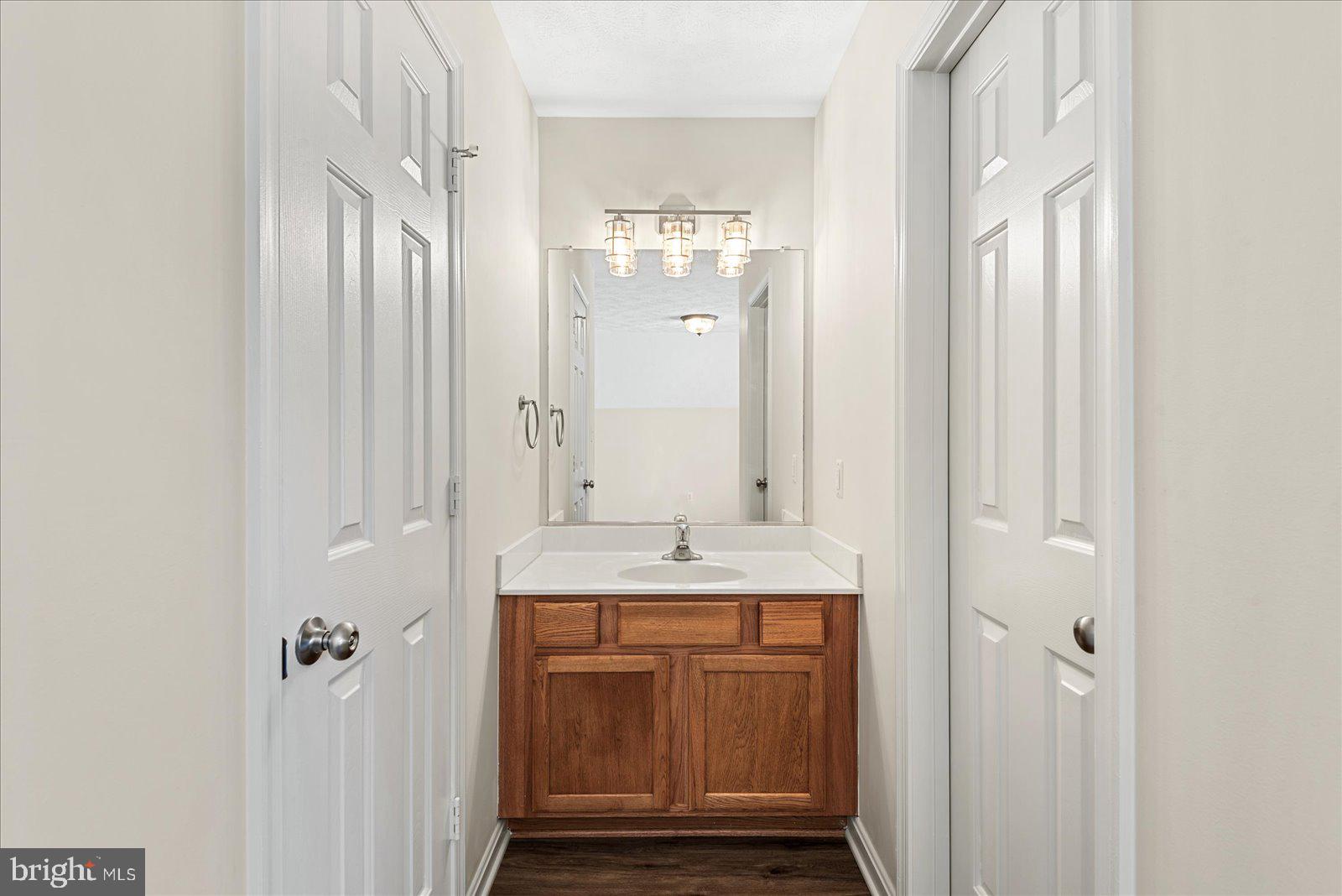 321 3rd Street Colonial Beach, VA 22443 - Photo 35 of 47 a bathroom with a granite countertop sink and a mirror