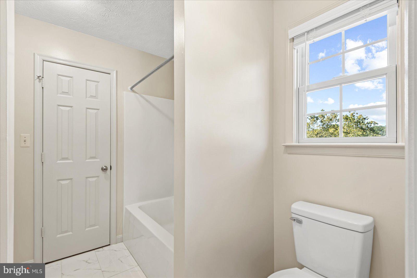 321 3rd Street Colonial Beach, VA 22443 - Photo 37 of 47 a bathroom with a sink a toilet and shower