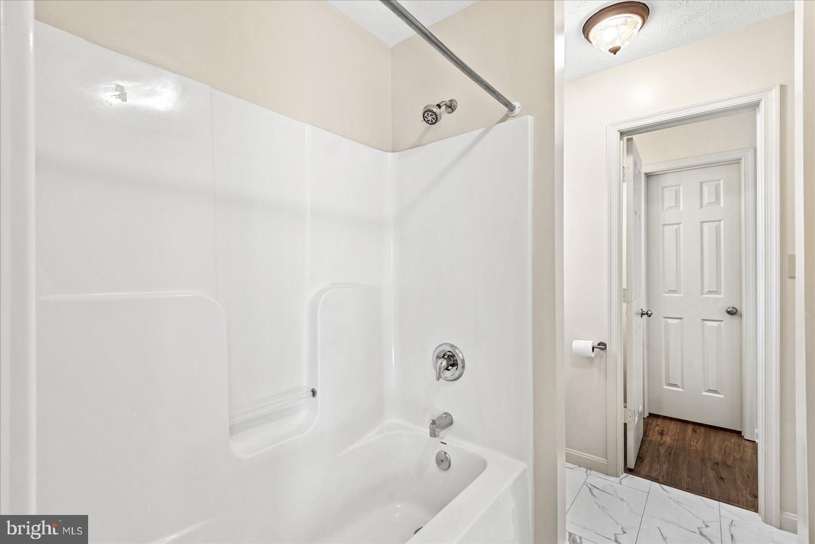 321 3rd Street Colonial Beach, VA 22443 - Photo 38 of 47 a bathroom with a bathtub and a shower