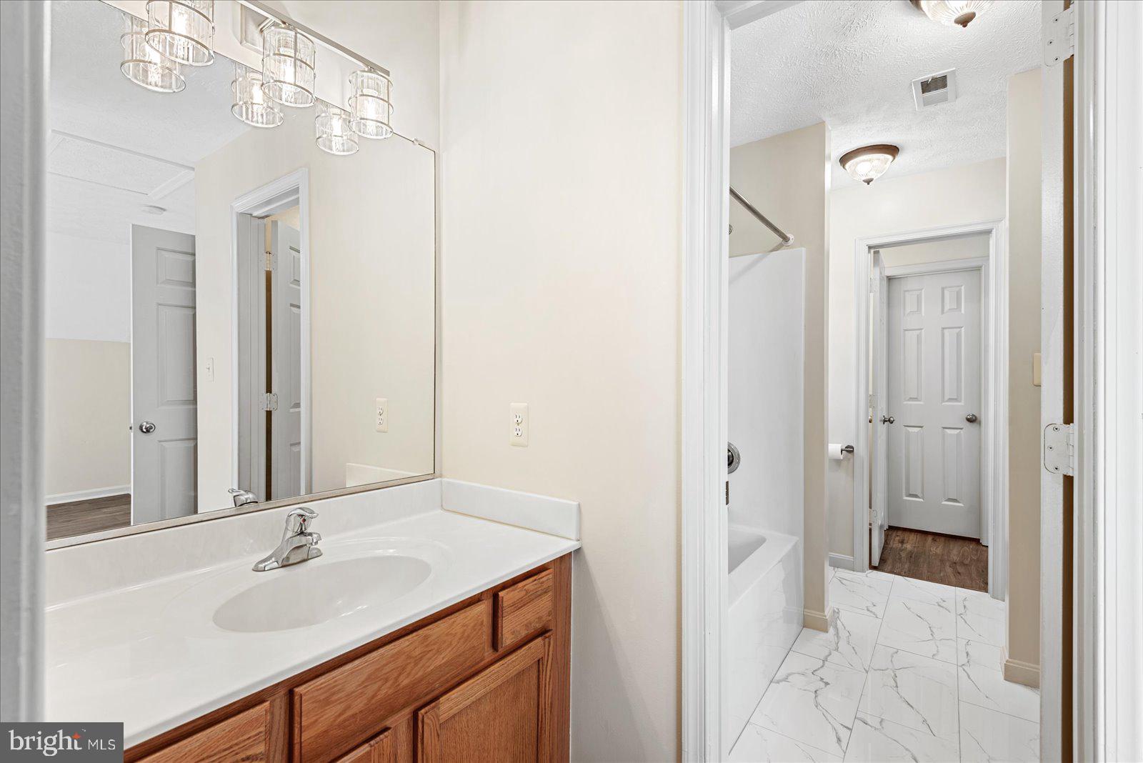 321 3rd Street Colonial Beach, VA 22443 - Photo 39 of 47 a bathroom with a sink and a mirror