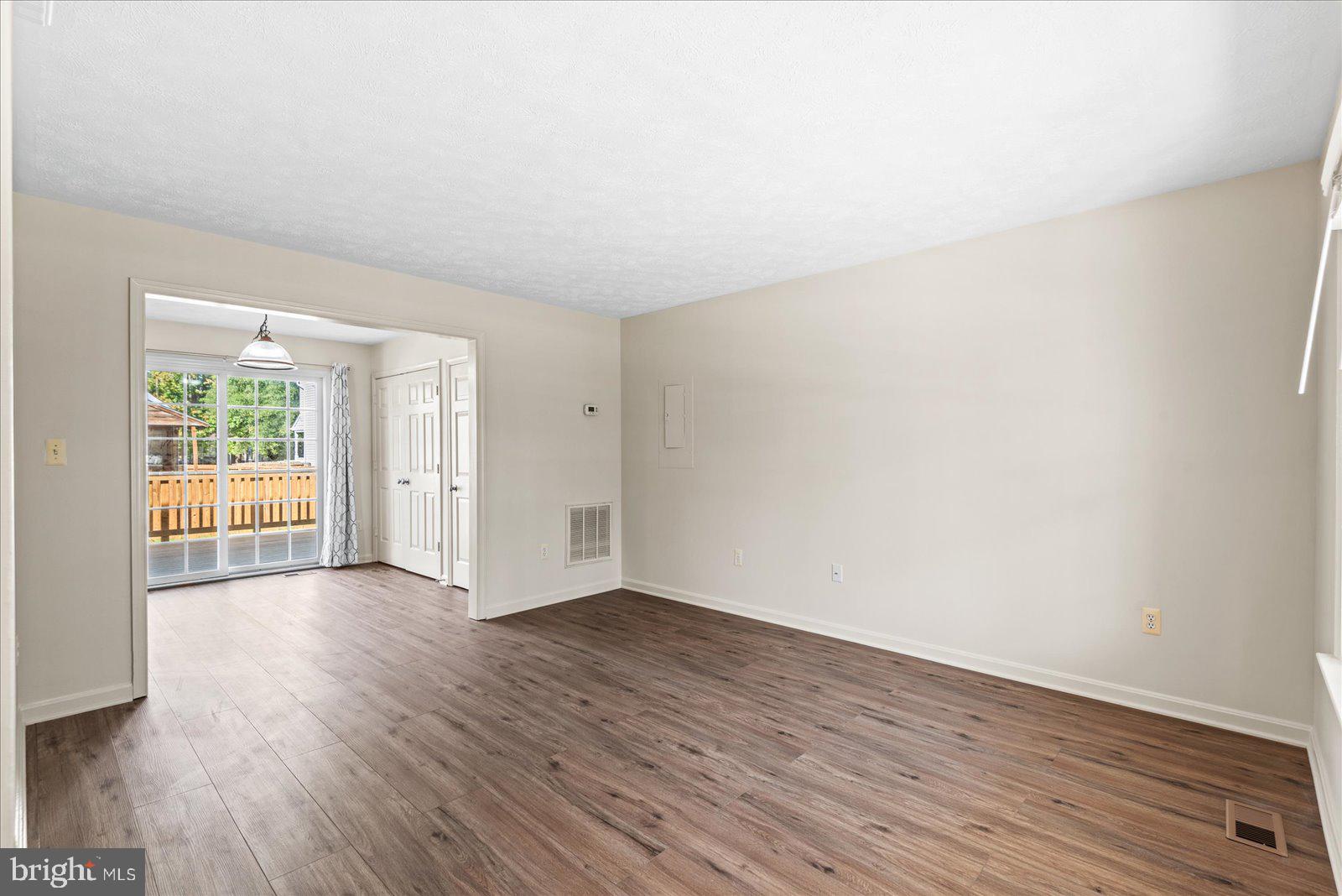 321 3rd Street Colonial Beach, VA 22443 - Photo 6 of 47 an empty room with wooden floor and windows