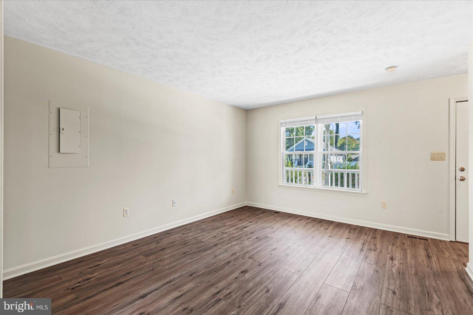 321 3rd Street Colonial Beach, VA 22443 - Photo 10 of 47 an empty room with wooden floor and windows
