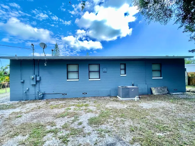 a front view of a house with plants